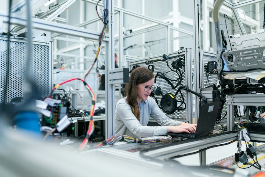 An engineer working at a manufacturing station